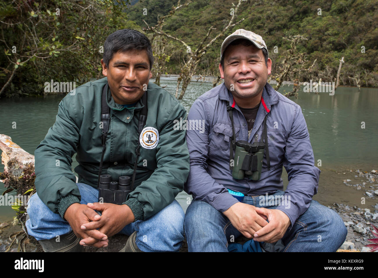 Two local guides posing for picture in Peru's Cloud Forest, based out of Wayqecha Biological Research Station, while hiking through rainforest Stock Photo