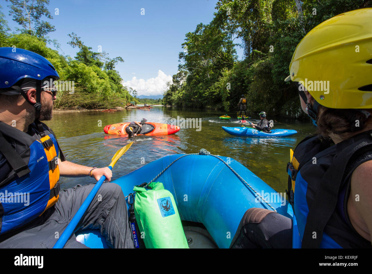 Photograph of white water rafters and kayakers on jungle river, Manu National Park, Peru Stock Photo