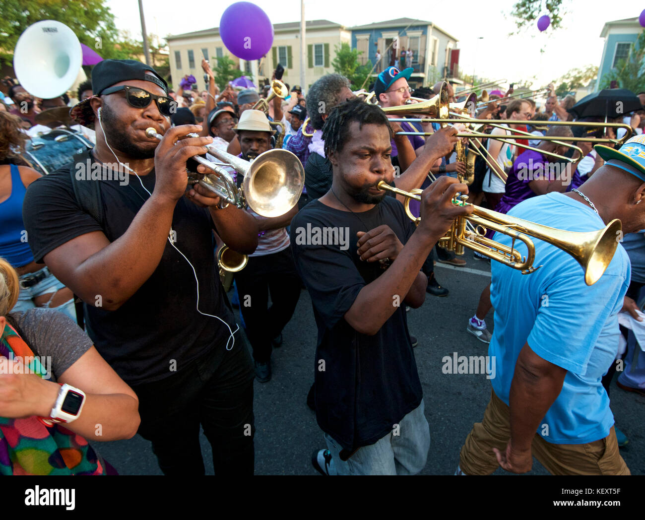 A brass band leads a second line parade in the French Quarter of New Orleans, Louisiana Stock Photo
