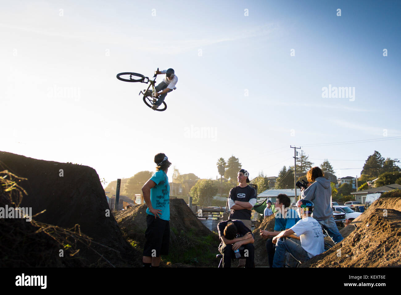 Ryan Howard does a run through the jump as other riders look on. Post
