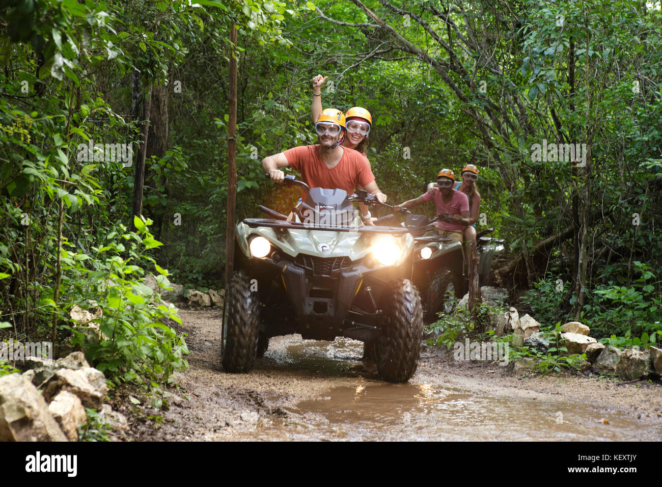 Front view of couples riding quad bikes in Emotions Native Park, Quintana Roo, Mexico Stock Photo