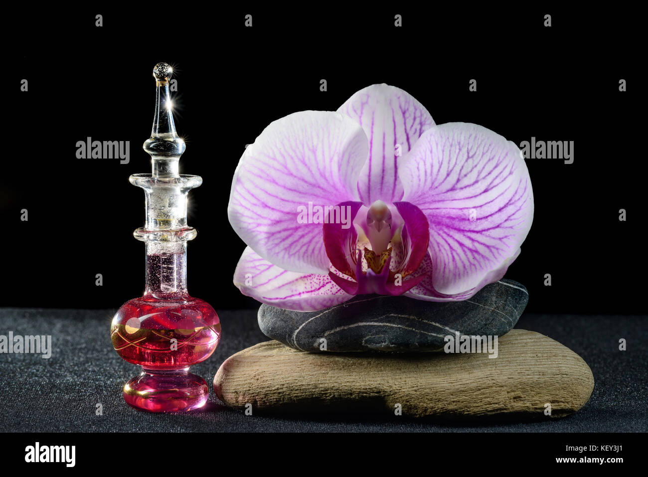 Orchid and perfume bottle Stock Photo