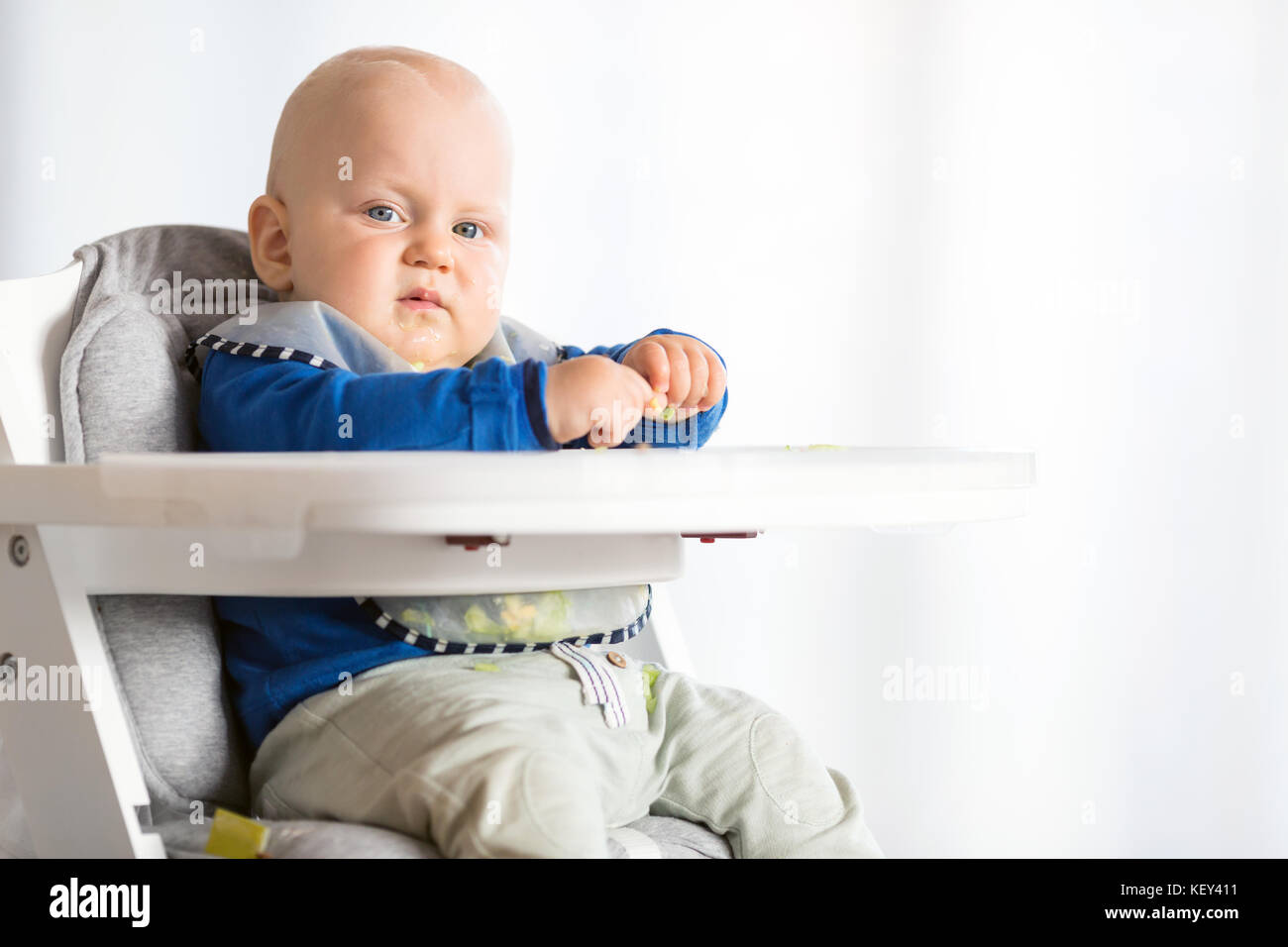 Baby eating bread and cucumber with BLW method, baby led weaning