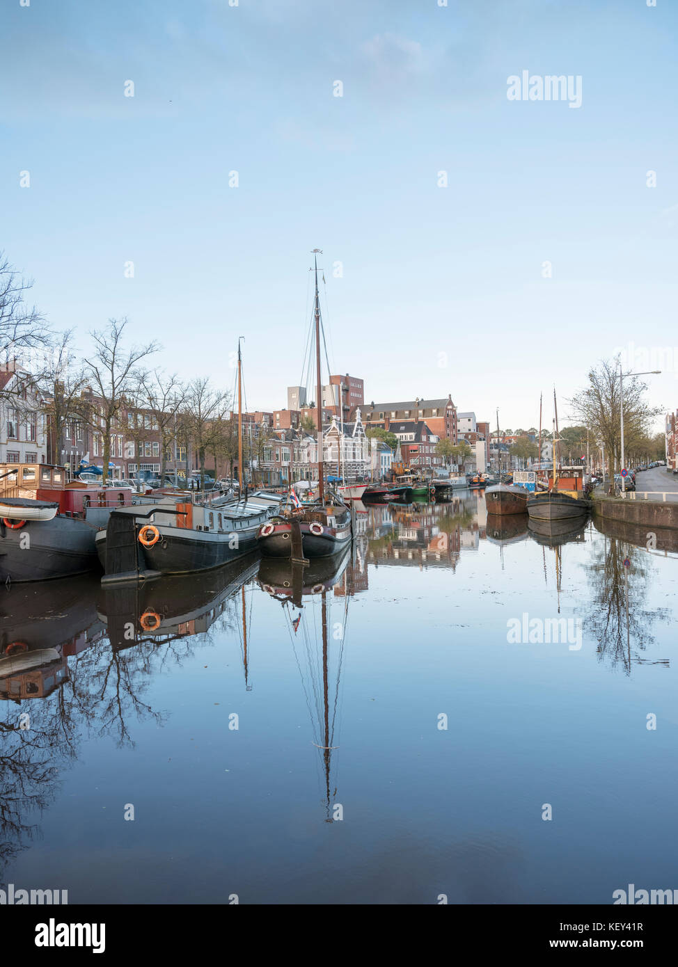 old harbour with houseboats in the old city of groningen in holland  Stock Photo