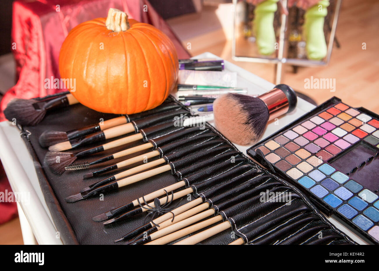 Set of brushes for makeup in a black cover with pumpkin. Halloween making up objects Stock Photo