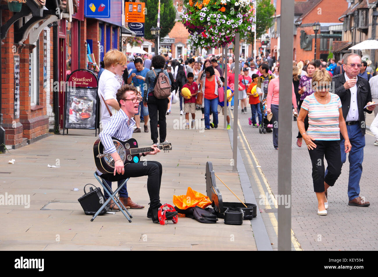 Young buskers  entertaining the tourists with Beatles songs in  Stratford on Avon, Warwickshire.UK Stock Photo
