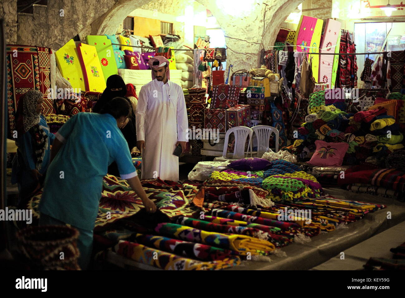 DOHA, QATAR APRIL 23, 2017 Shoppers buying textiles in Souq Waqif market in Qatar, Arabia, at