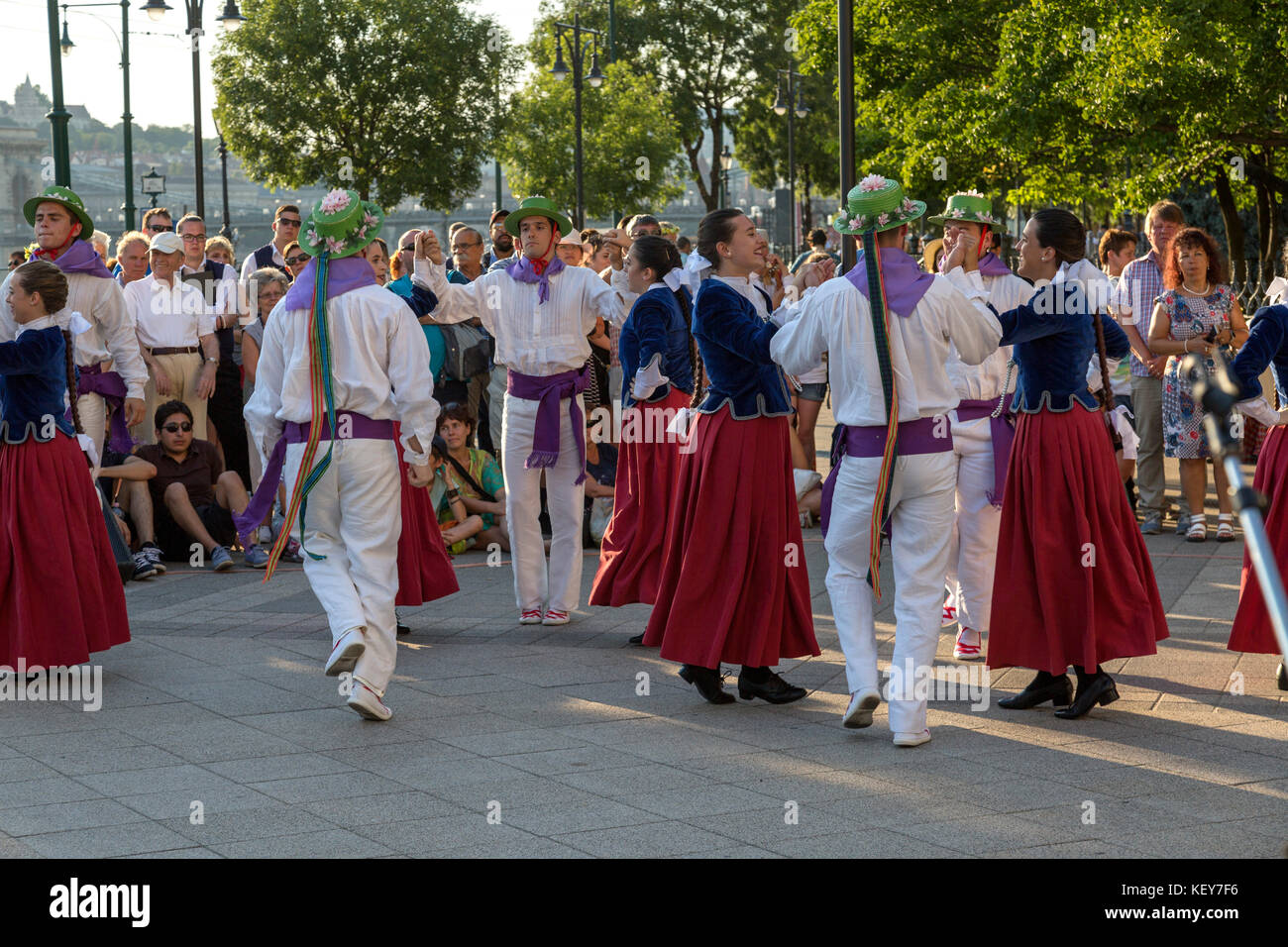 Tourists watch as performers do a traditional Hungarian dance dress in traditional costume. Stock Photo