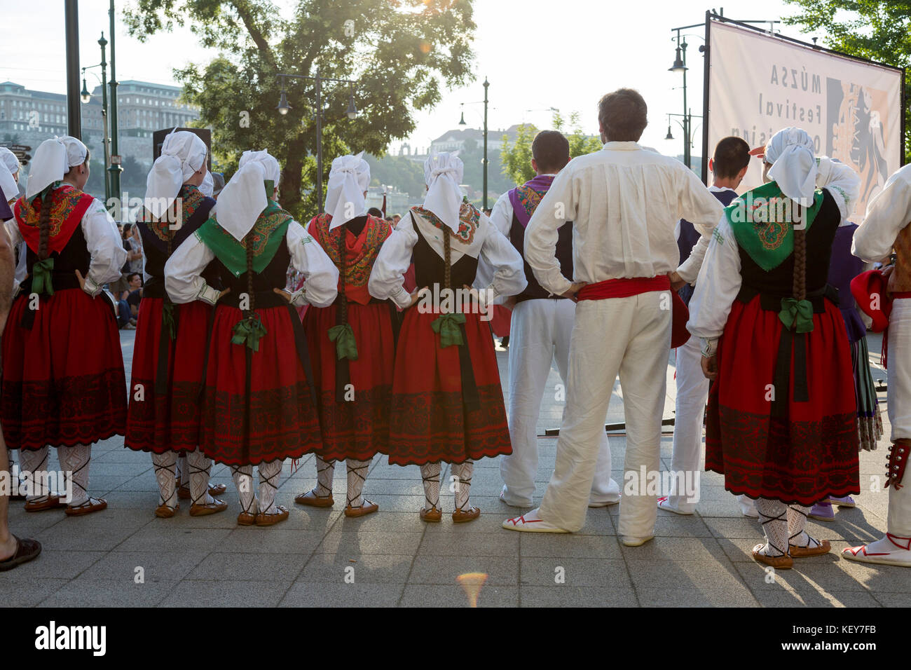 Tourists watch as performers do a traditional Hungarian dance dress in traditional costume. Stock Photo