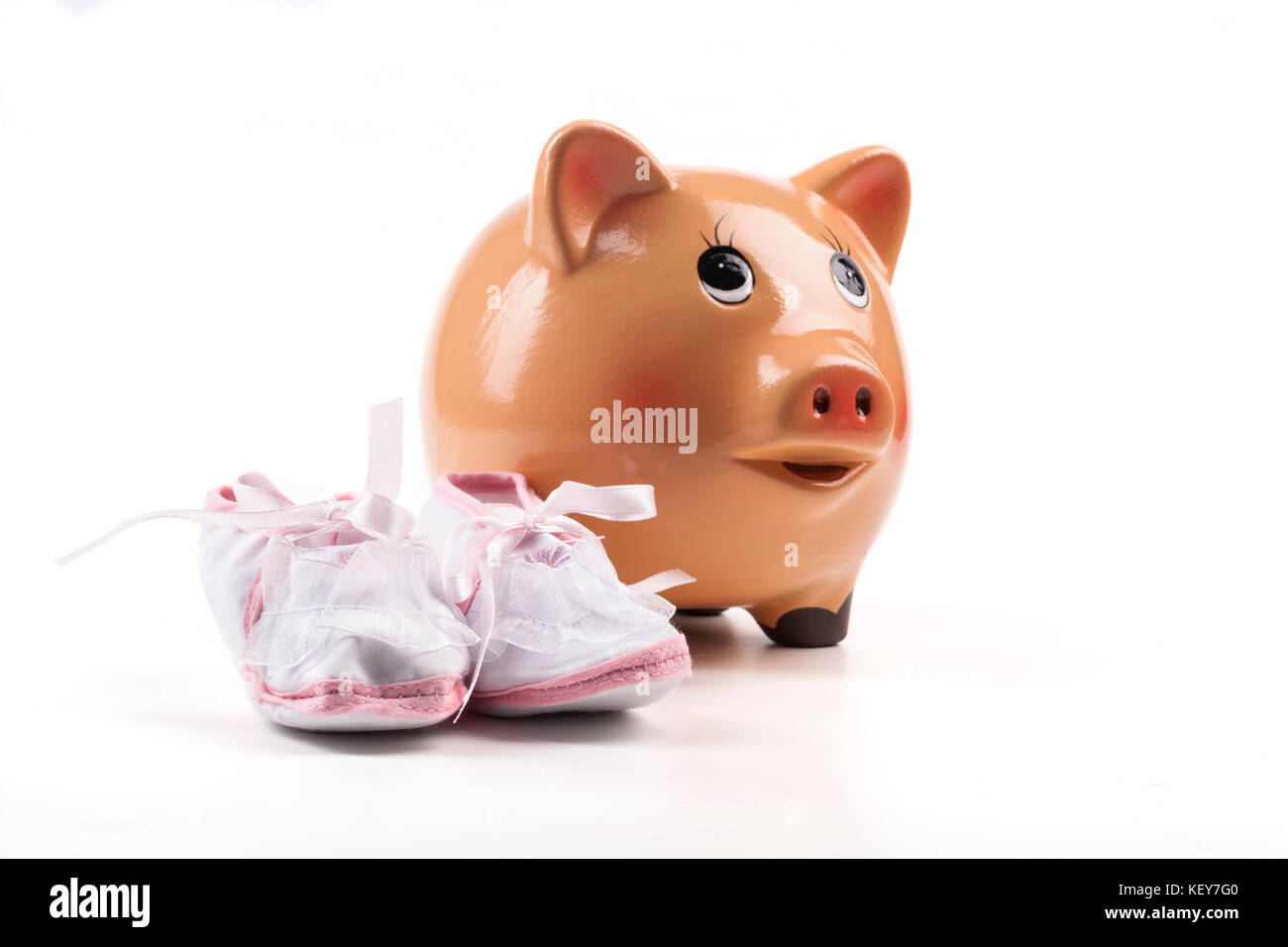 Baby Newborn Shoes with Piggy Bank Isolated on White Background Stock