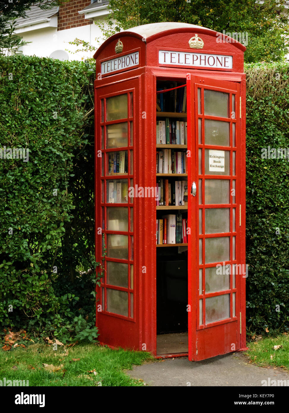 A novel way to use an old red phone box into as a free  community book exchange. Stock Photo