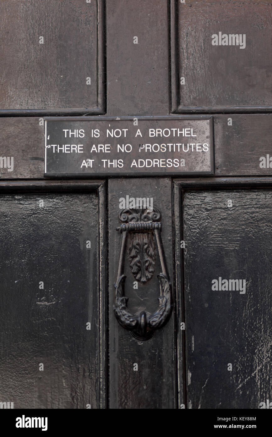 Sign on door saying: This is not a Brothel There are no prostitutes living at this address. Stock Photo