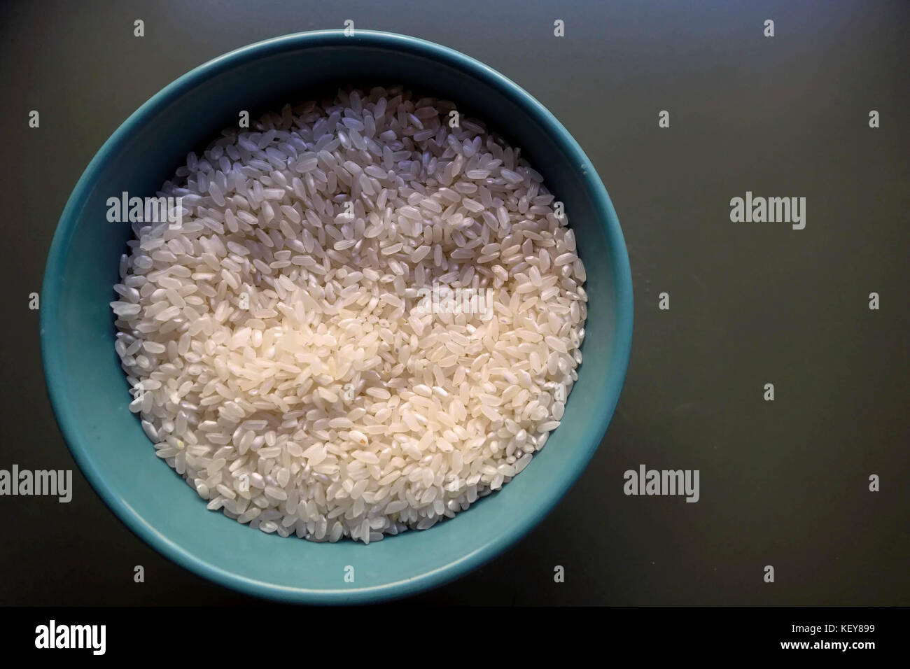 A Bowl of Uncooked White Rice Stock Photo Alamy