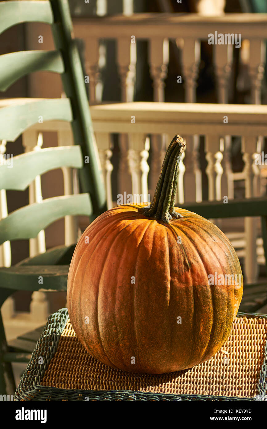 A pumpkin on the porch of a house in Lancaster, Pennsylvania, USA. This is a typical, modest Halloween decoration. Stock Photo