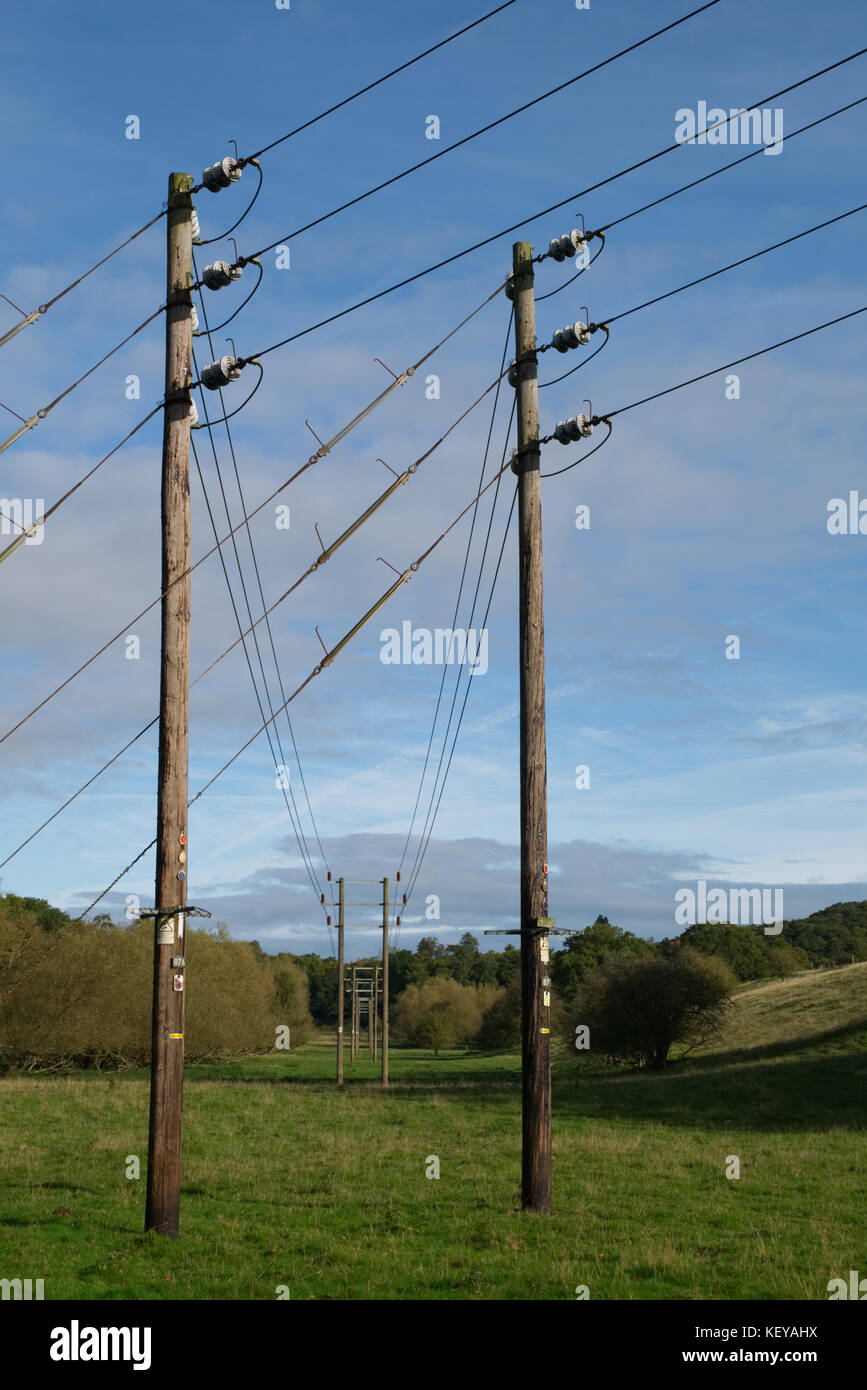 Electrical power lines on blue sky with clouds background Stock Photo ...