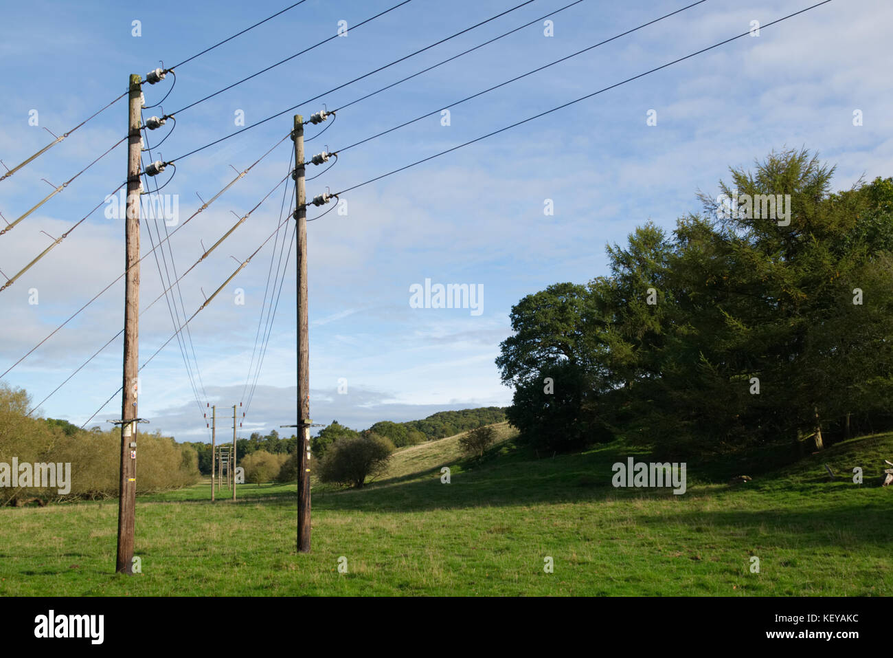 Electrical power lines on blue cloud sky background Stock Photo - Alamy