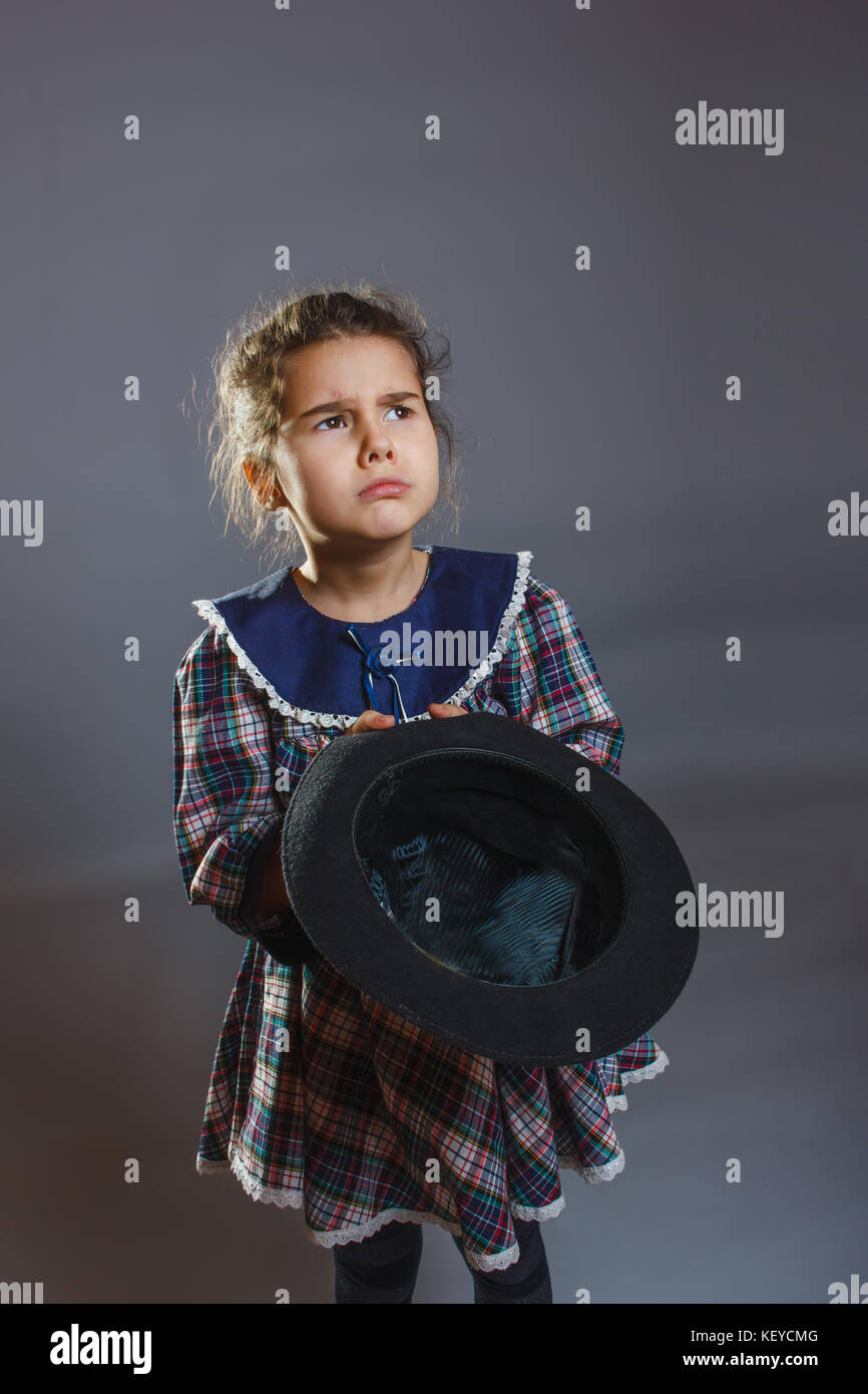 girl with hat in hand asking coins Stock Photo