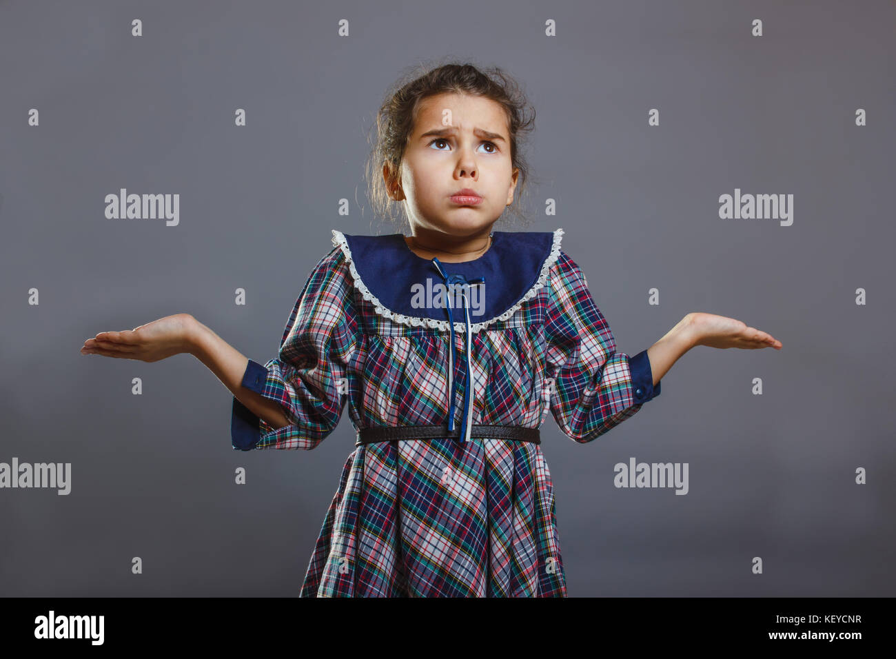 baby girl throws up his hands in disbelief Stock Photo Alamy
