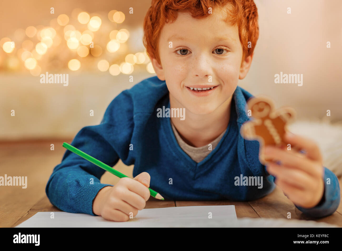 Adorable redhead child drawing on floor Stock Photo