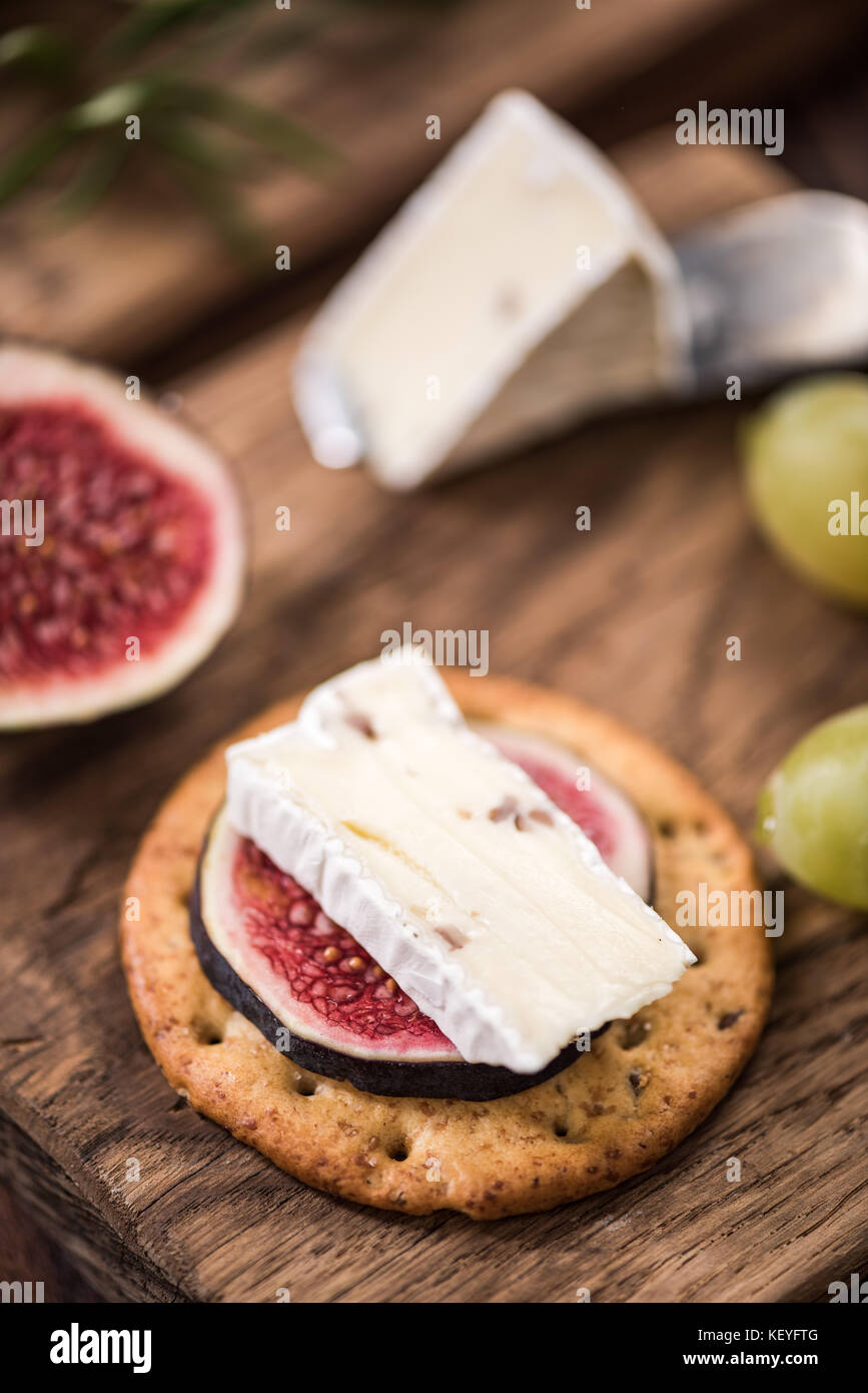 Cheese crackers with camembert and fresh fig Stock Photo Alamy