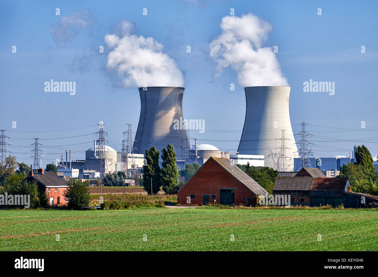 Steam rising from the two cooling towers of the  Nuclear Power Plant at the small village if Doel in Flanders, Belgium very close to the Dutch border Stock Photo