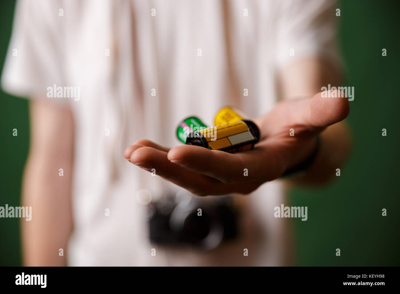 Cropped photo of male hand, holding camera rolls, selective focus Stock Photo