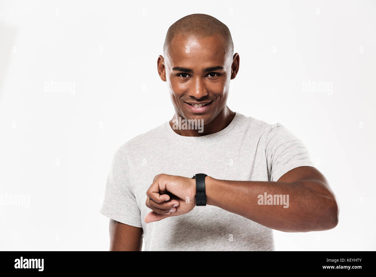 Photo of cheerful young african man standing isolated over white ...