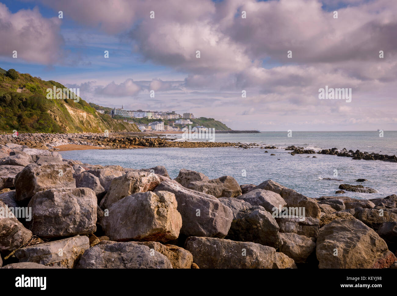 A view to Ventnor in the distance across the foreshore from Steephill Cove. Stock Photo