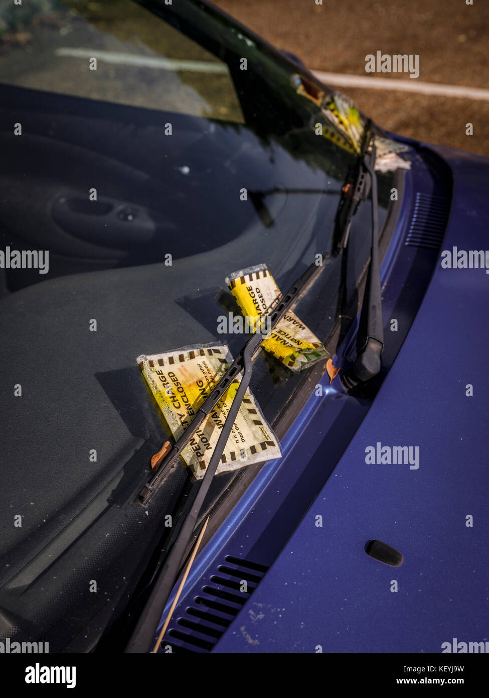 A car covered with several parking fines - Ventnor long stay car park, Isle of Wight. Stock Photo