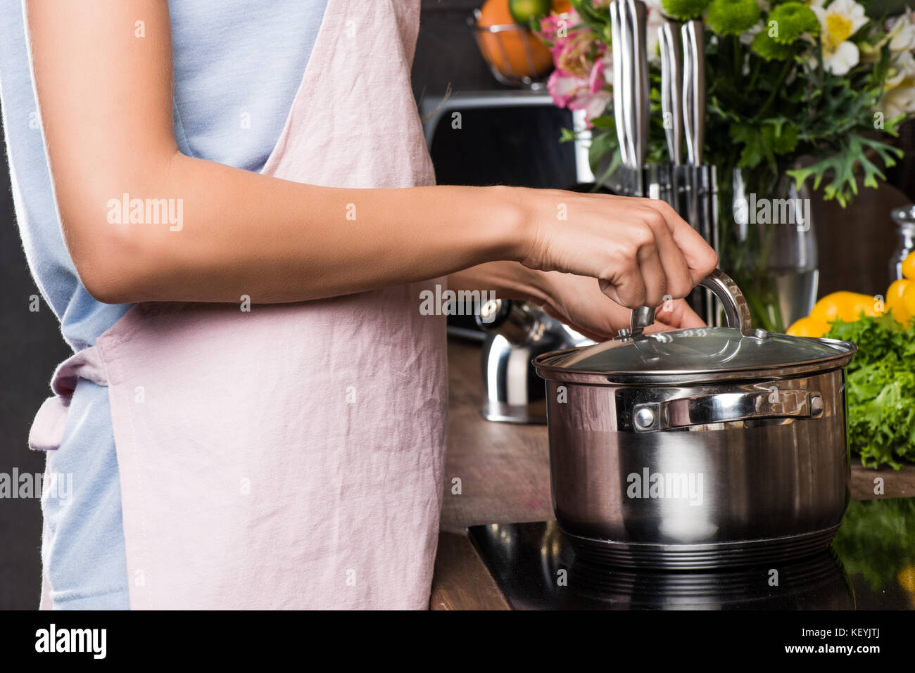 woman preparing food in saucepan Stock Photo