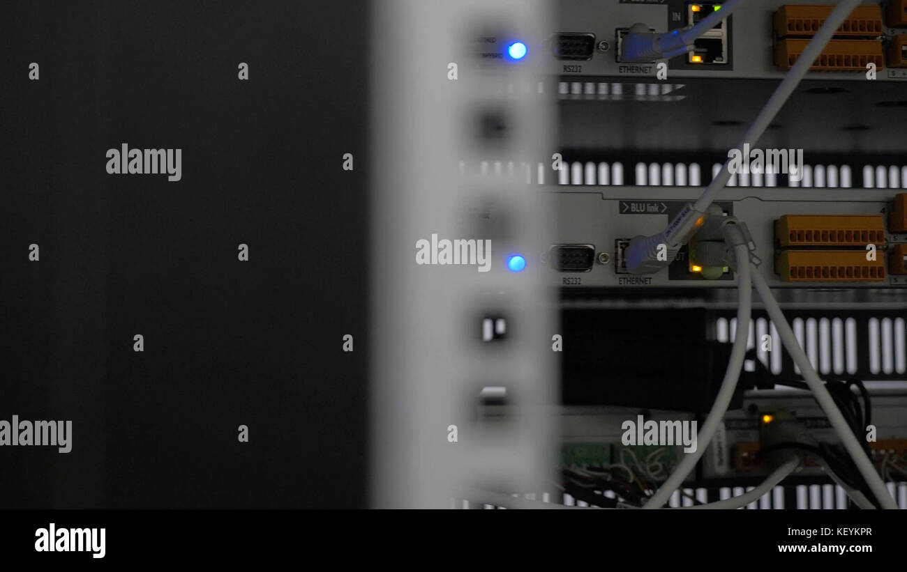 Back of the server installed in the server room. Many cables are ...