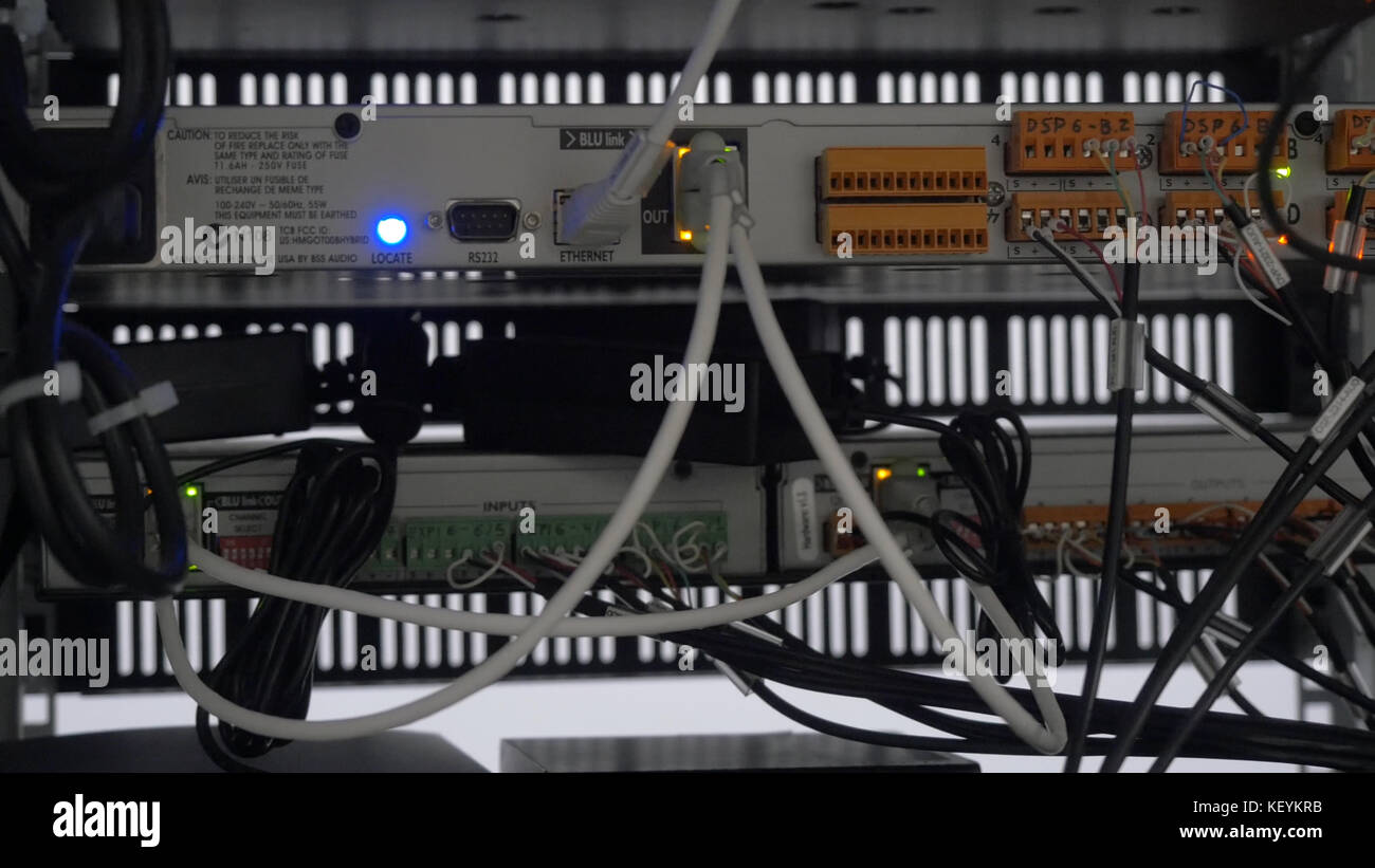 Back of the server installed in the server room. Many cables are ...