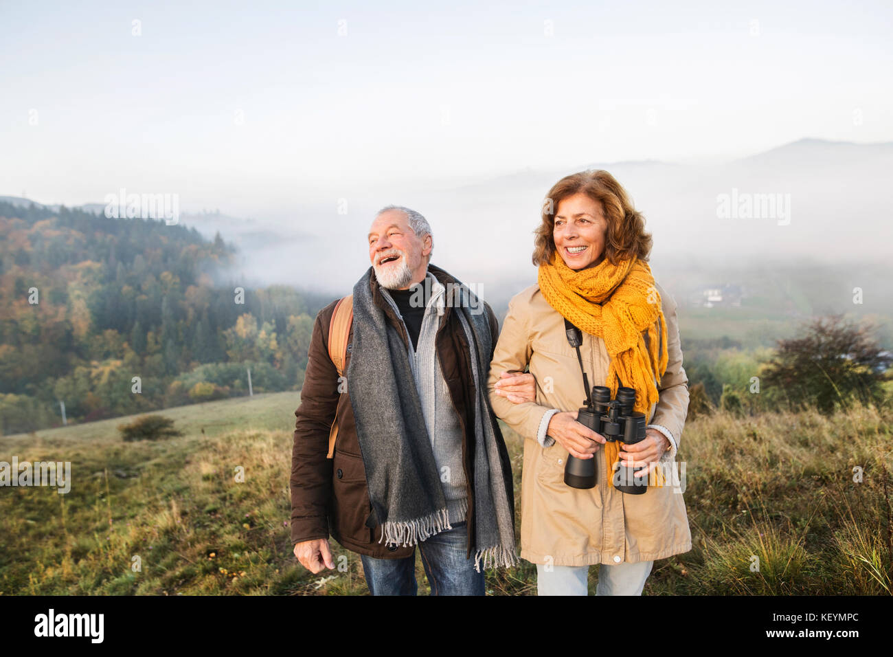 Active senior couple on a walk in a beautiful autumn nature Stock Photo ...