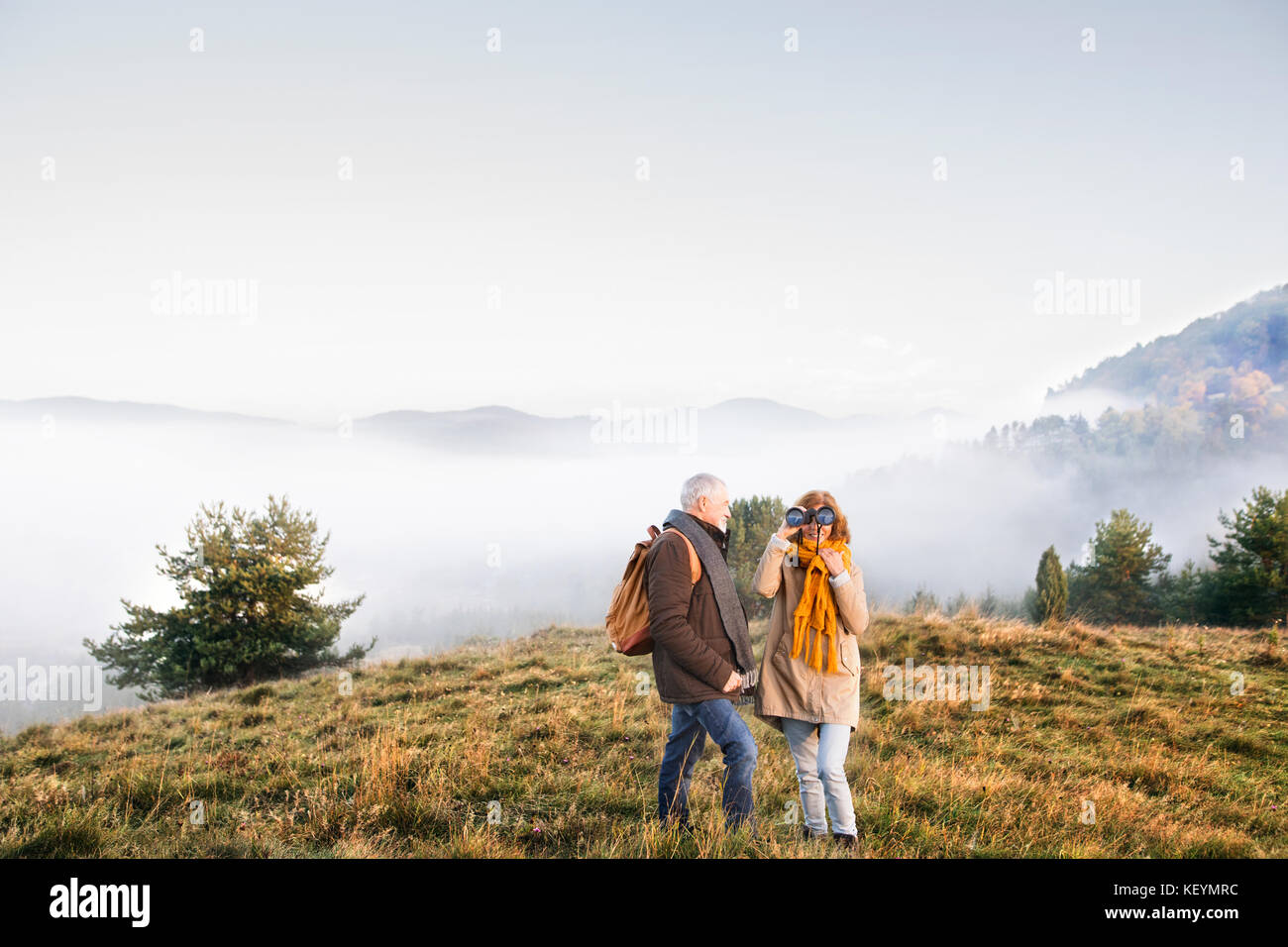 Active senior couple on a walk in a beautiful autumn nature Stock Photo ...