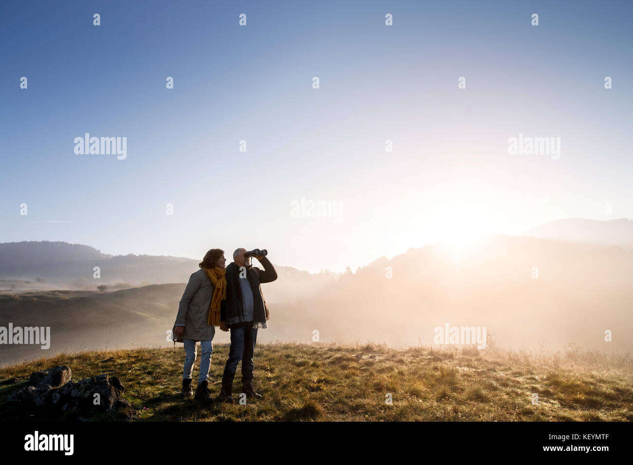 Active senior couple on a walk in a beautiful autumn nature Stock Photo ...