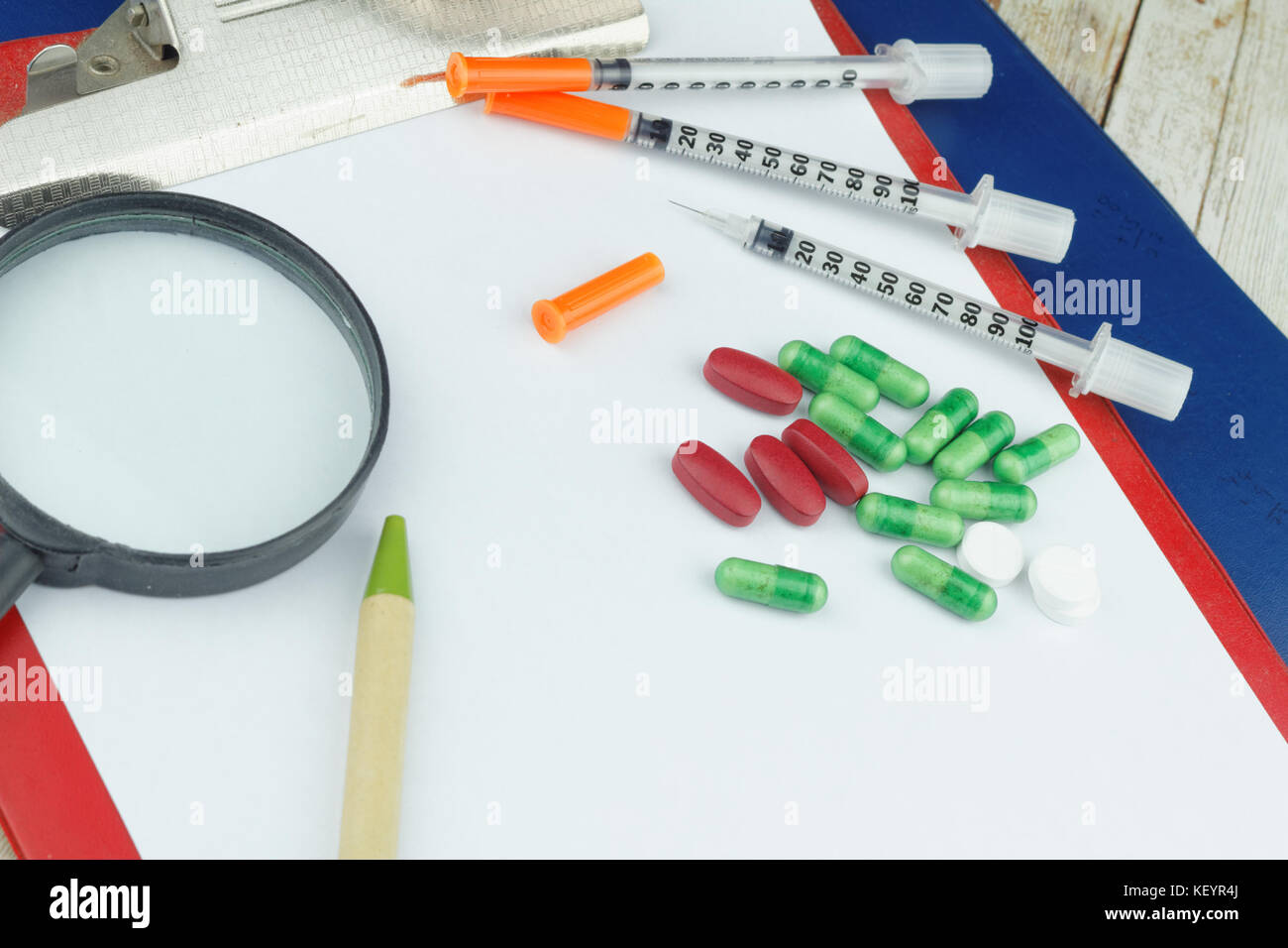 Healthcare concept. Capsule,caplet,tablet and syringe on isolated white
