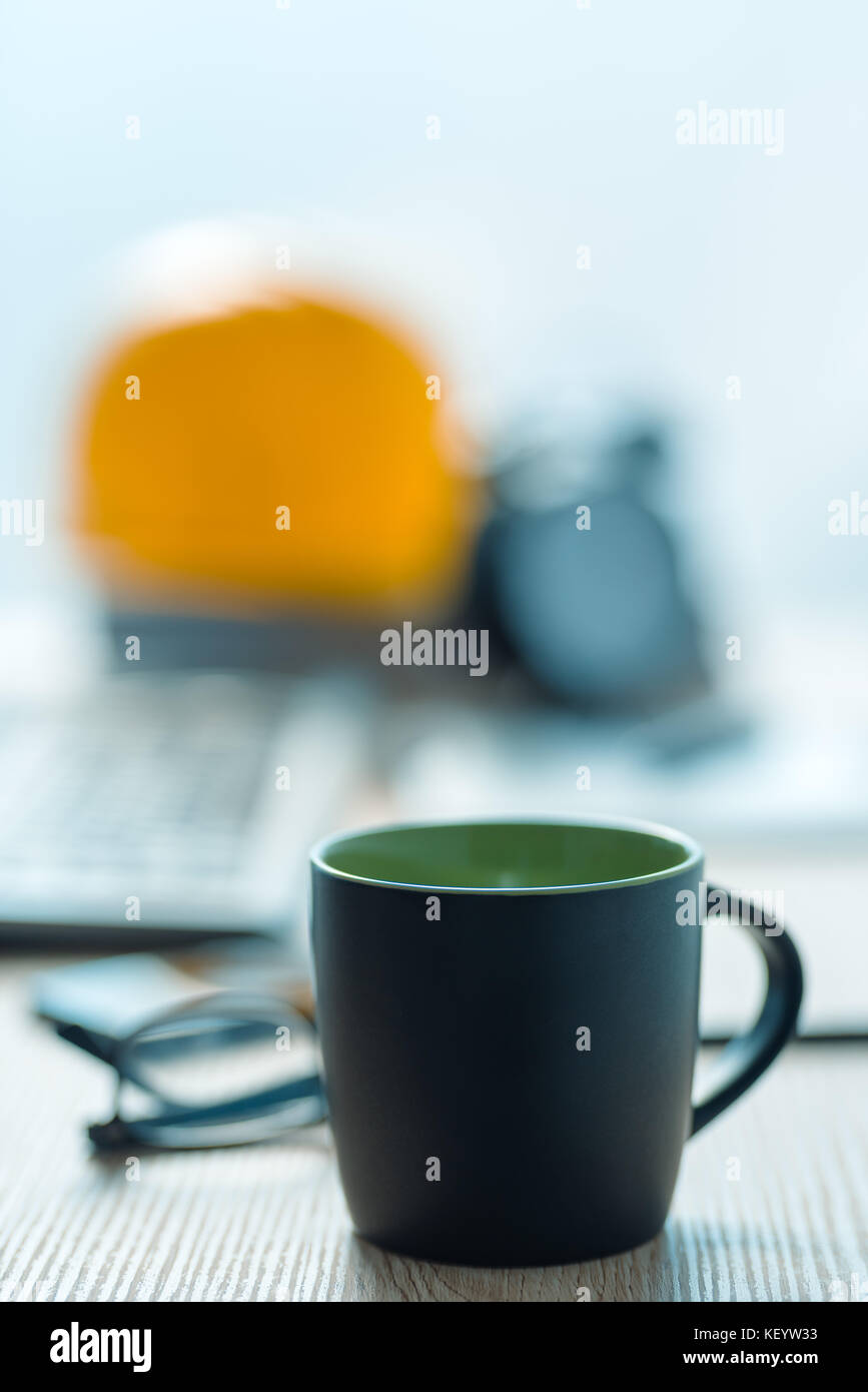 Coffee break in architecture and interior design studio, black cup of hot drink on office desk Stock Photo