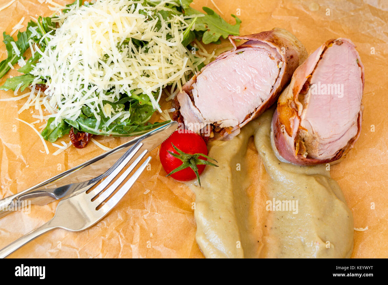 Roasted tenderloin with arugula salad and eggplant puree. Stock Photo