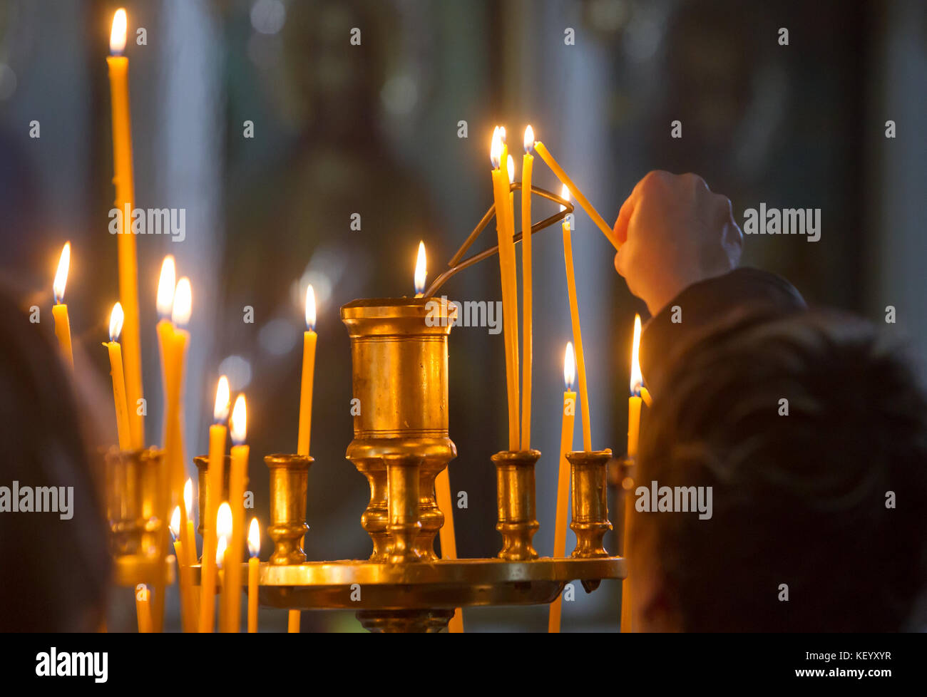 Woman lighting candle in orthodox hires stock photography and images