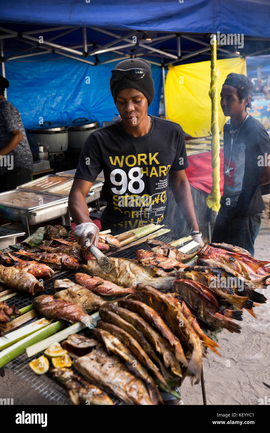 The Seychelles, Mahe, Beau Vallon, Tourist Market, man barbecuing fish