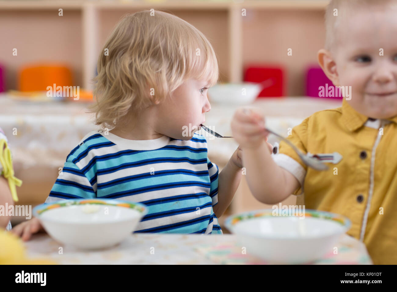 Kids eating in kindergarten Stock Photo