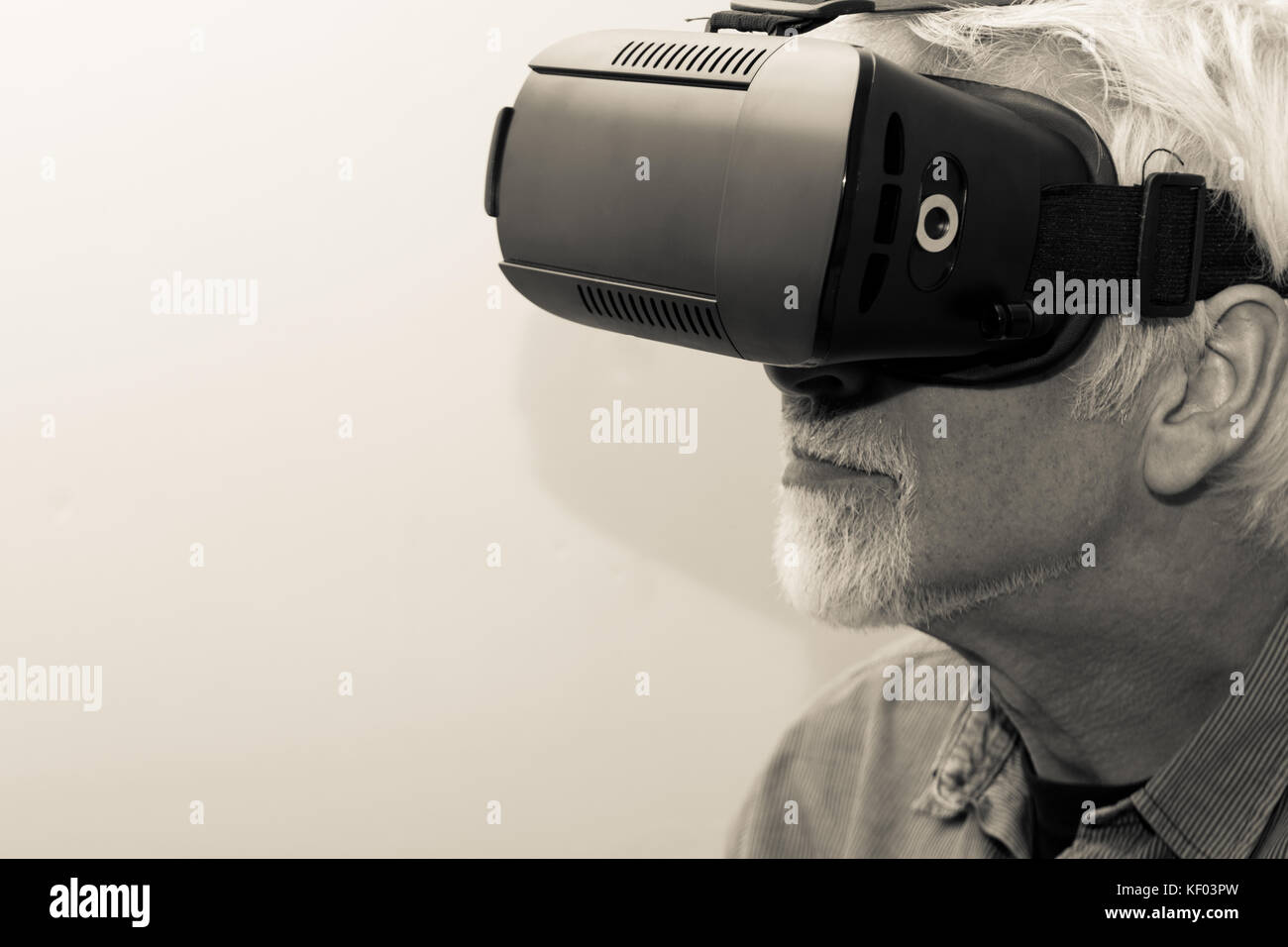 A mature model wearing and using virtual reality headset Stock Photo ...