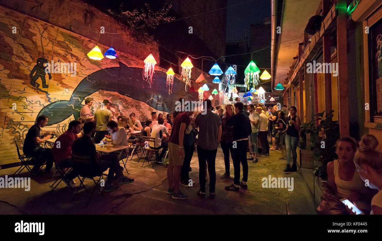 Horizontal panoramic view of a ruinpub in Budapest at night. Stock Photo