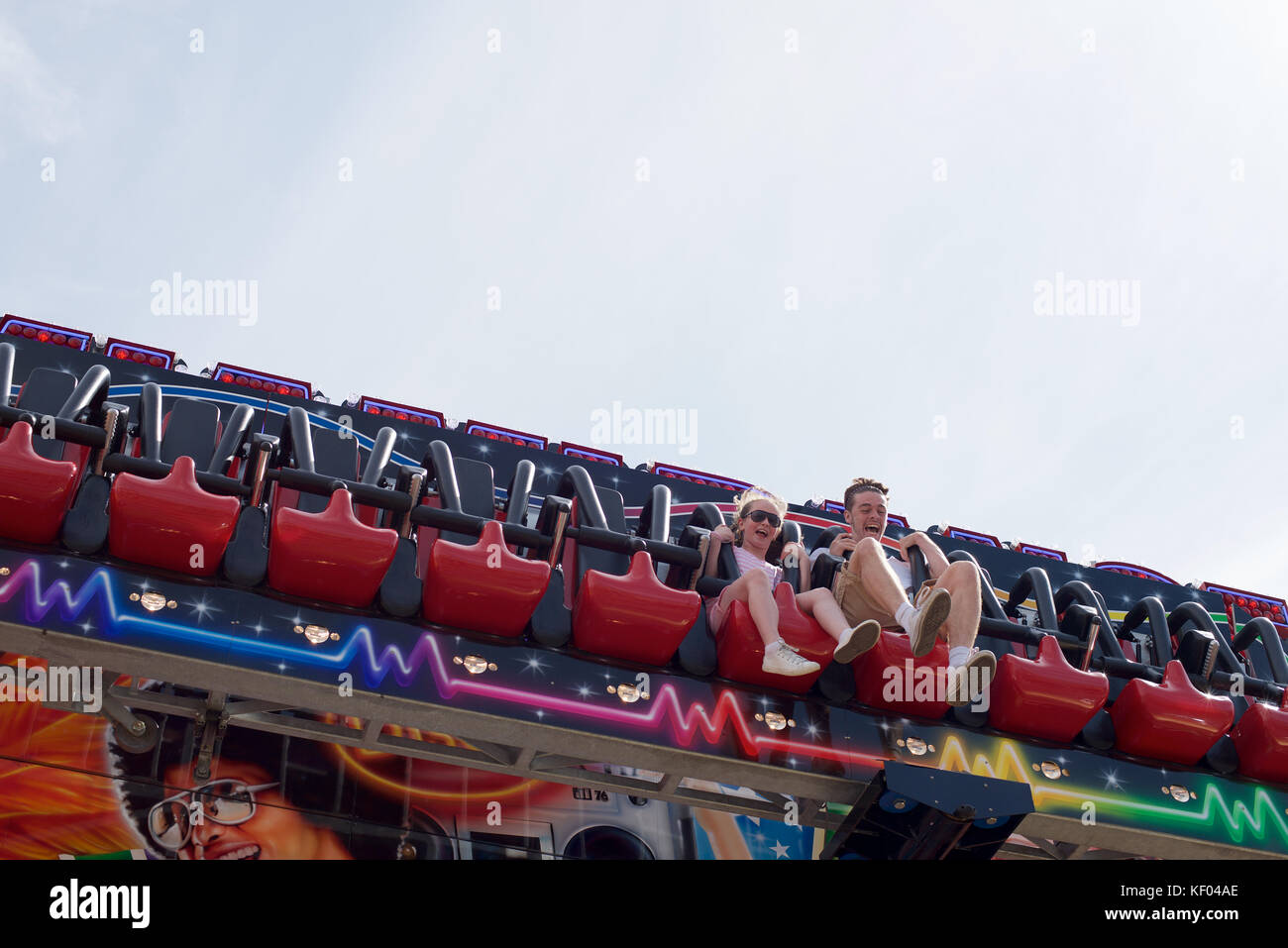 Two Rides Two young people sitting on an amusement ride Stock Photo - Alamy