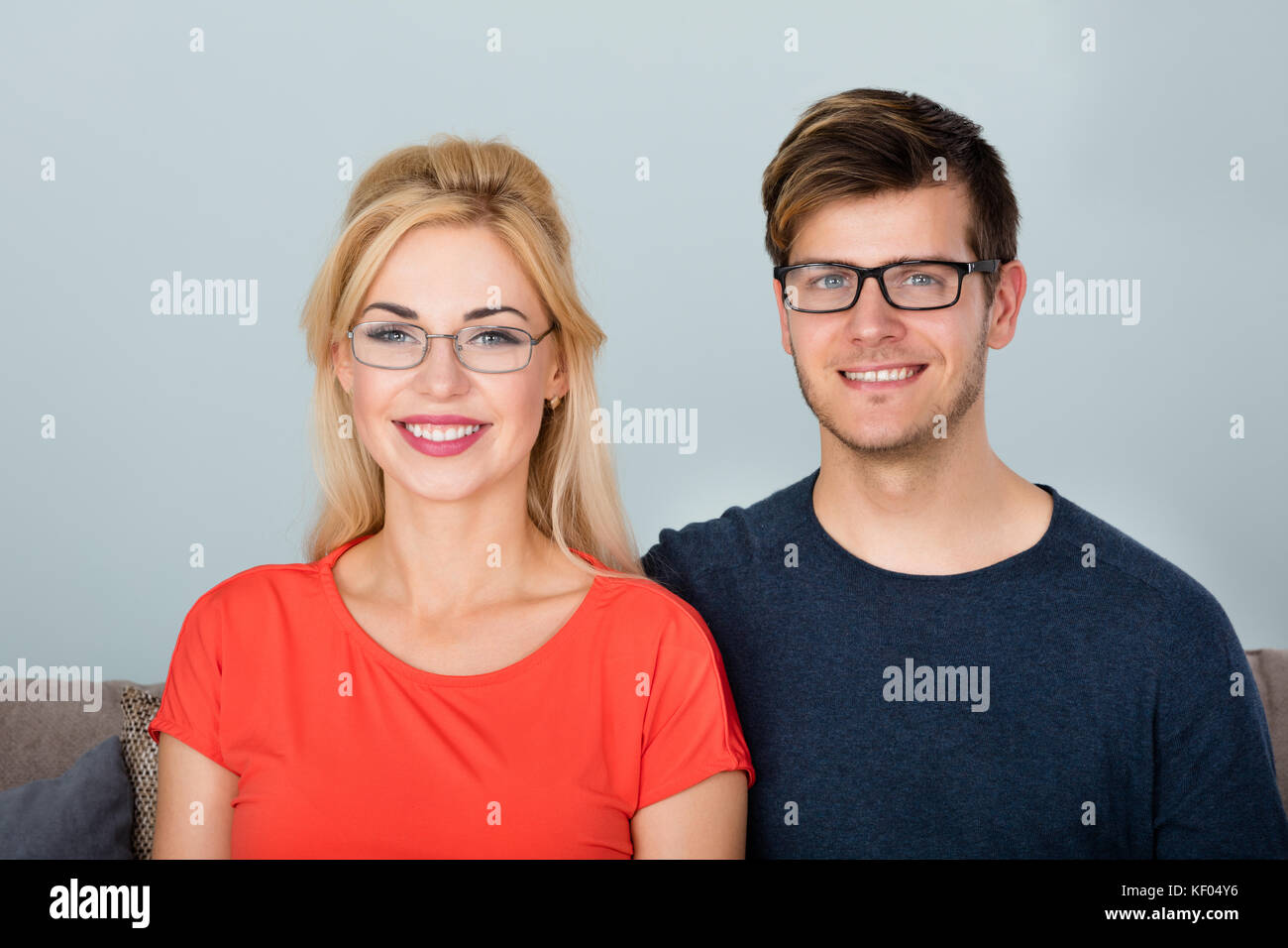 Portrait Of Young Smiling Couple Wearing Glasses Stock Photo