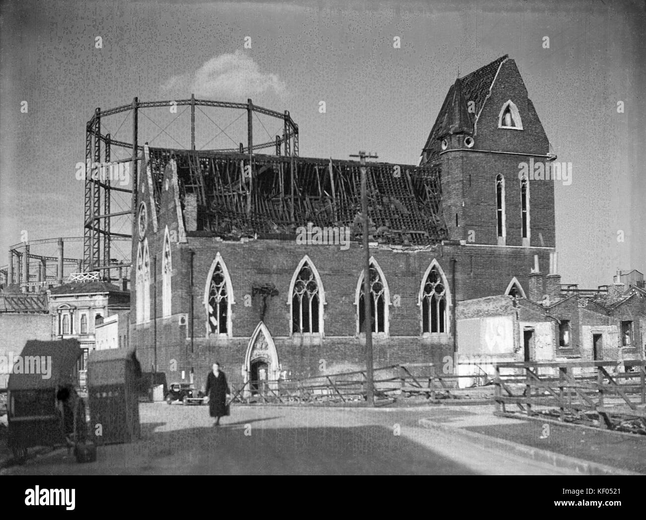 St John's Church, Halley Street, Limehouse, London. The church from the south showing its damaged roof, with gasometers beyond. The church has since b Stock Photo
