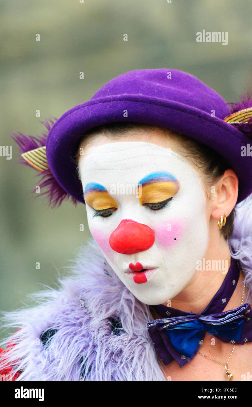 Female mime artist with painted face and costume performs on the high ...