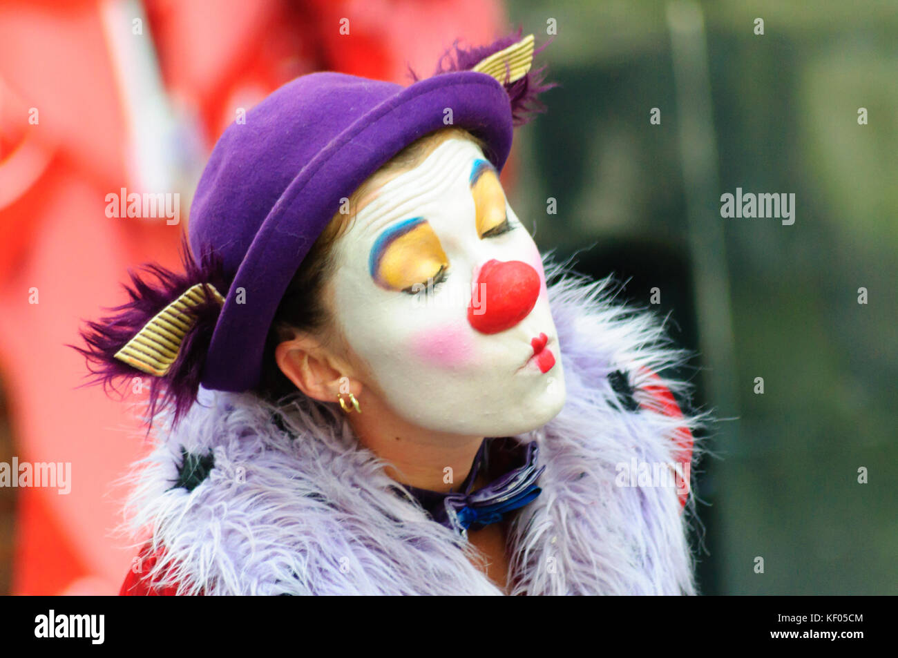 Female mime artist with painted face and costume performs on the high ...