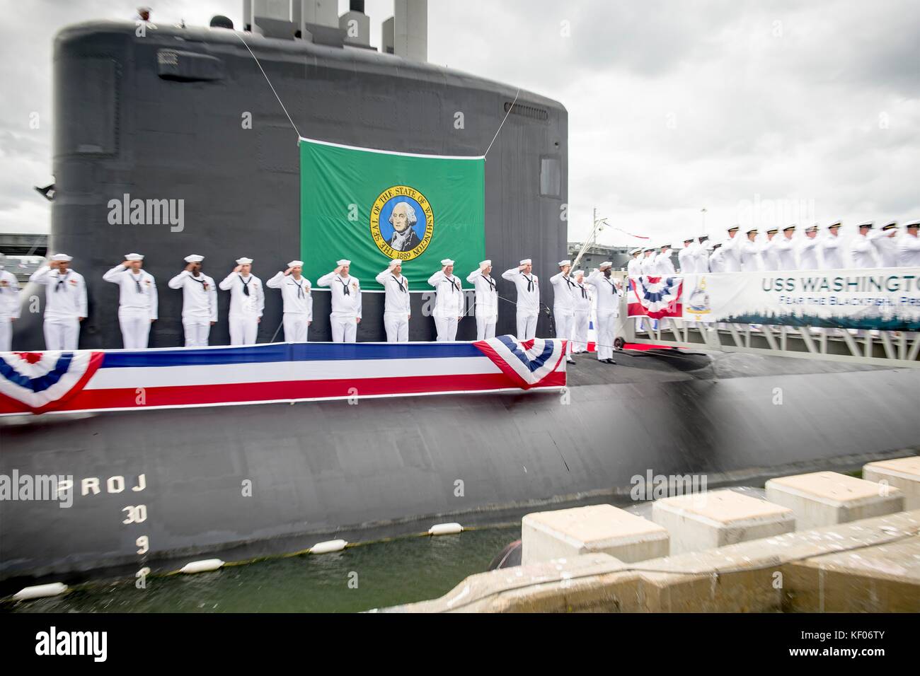 U.S. Navy sailors render honors aboard the U.S. Navy Virginia-class fast-attack submarine USS Washington during its commissioning ceremony at the Naval Station Norfolk October 7, 2017 in Norfolk, Virginia. Stock Photo