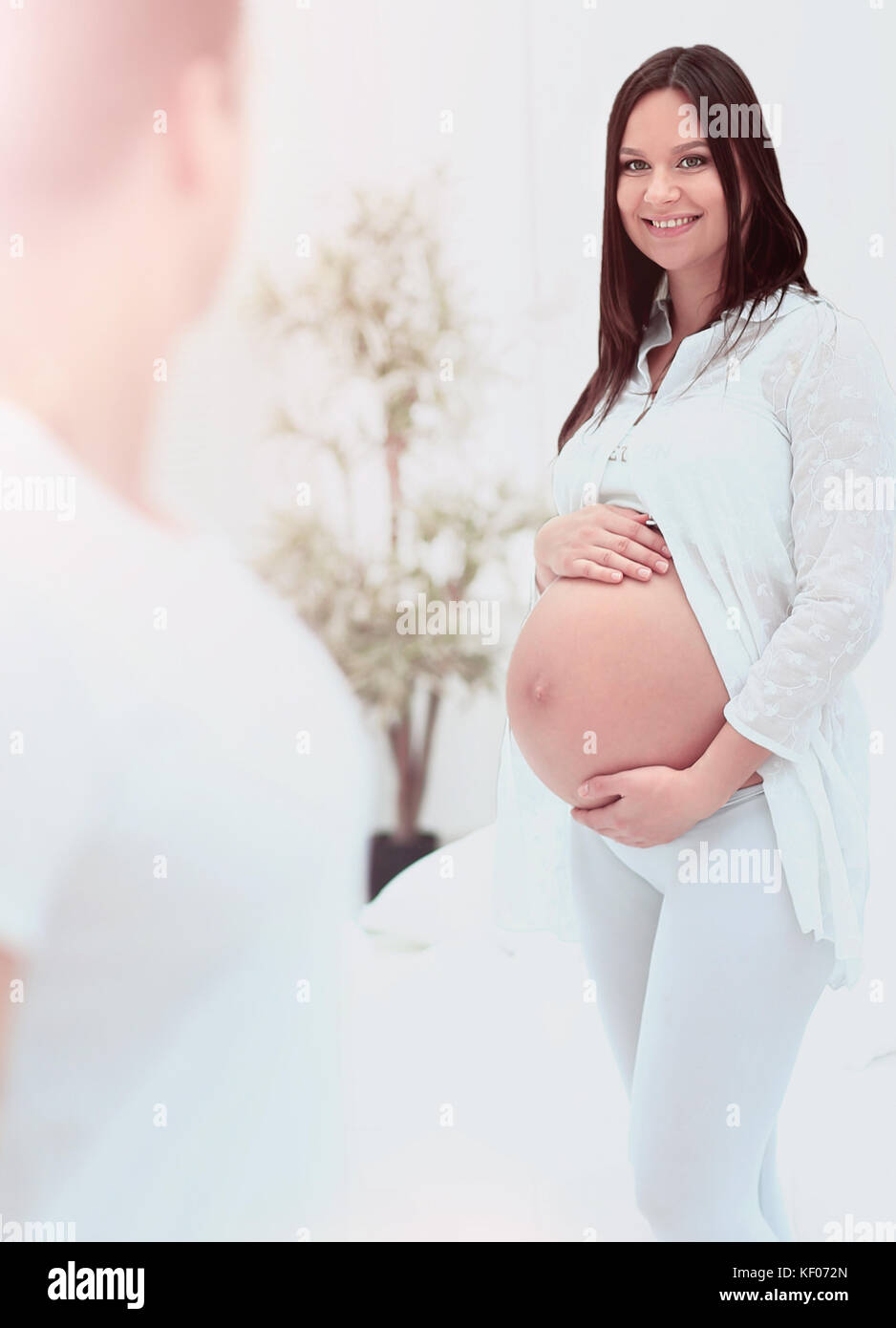 Pregnant wife relaxing on husband lap at home Stock Photo Alamy